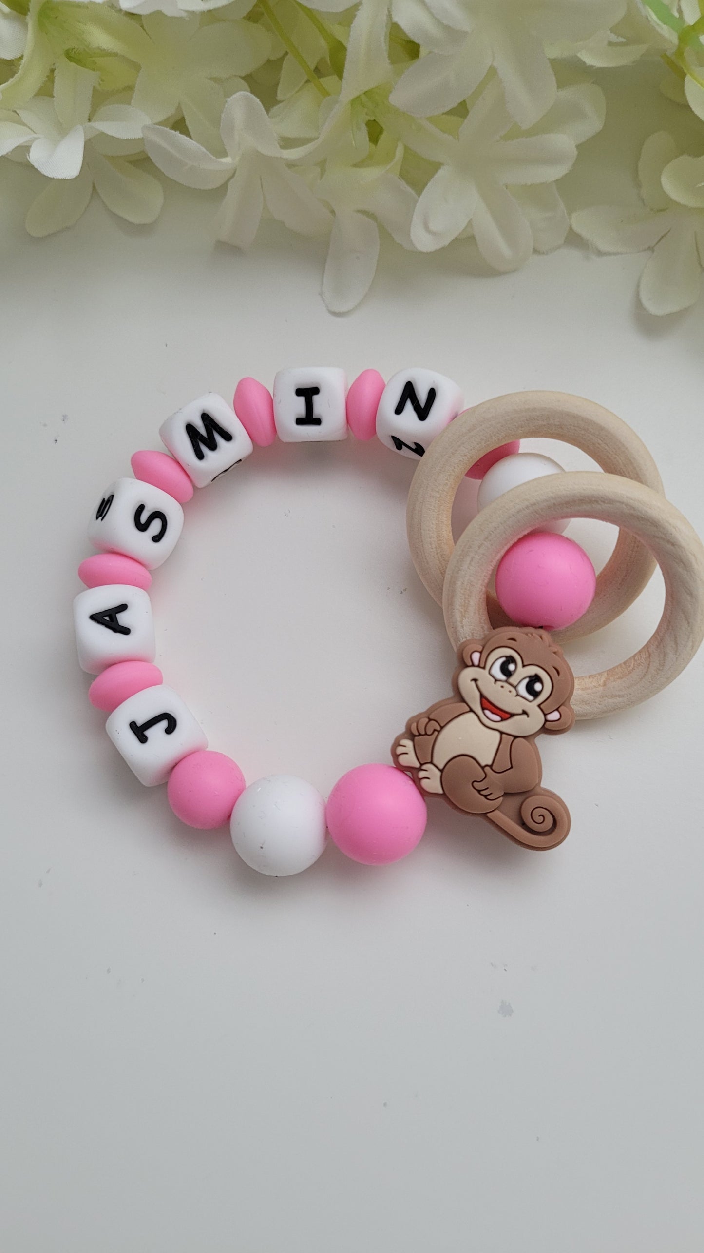Motorik Greifring mit Namen Affe pink
