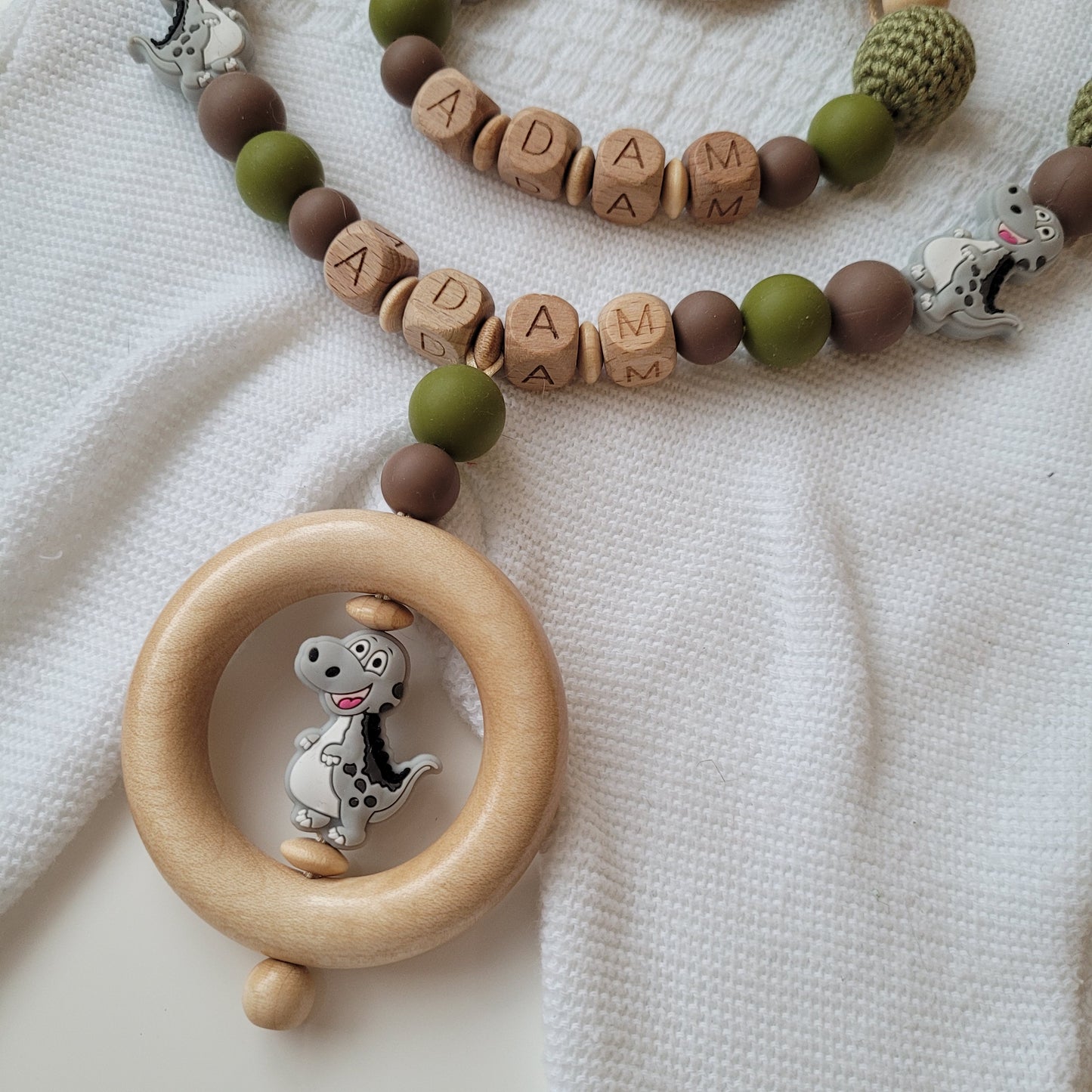 Kinderwagenkette & Schnullerkette mit Namen Dino grün holz braun