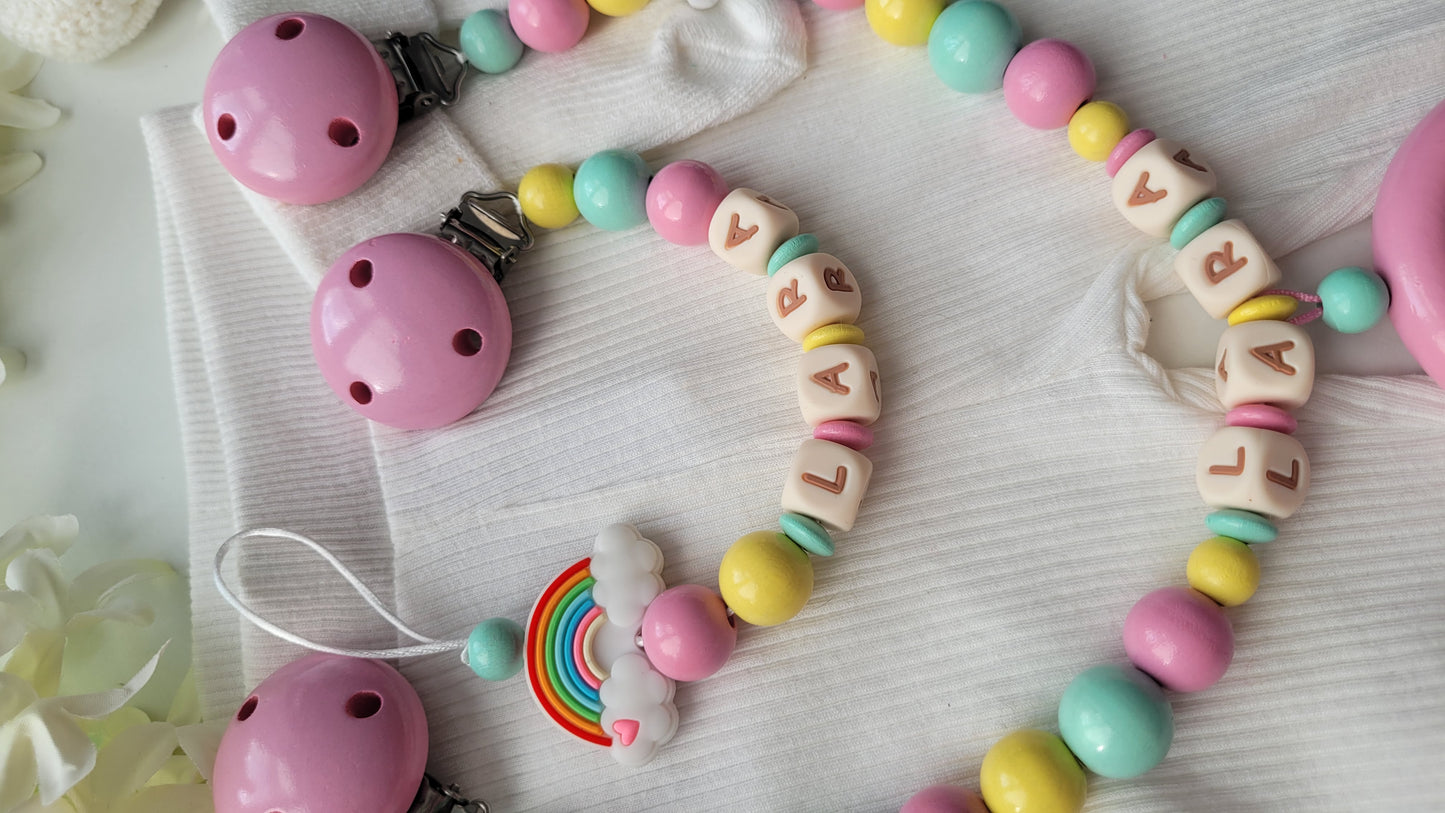 3er Set Schnullerkette, Kinderwagenkette & Greifring Regenbogen Pastellfarben