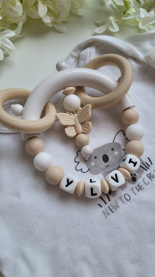 Motorik Greifring mit Namen Schmetterling beige