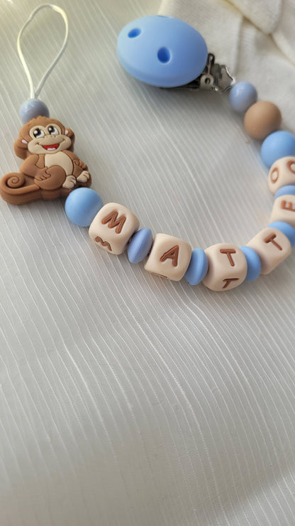 Kinderwagenkette & Schnullerkette mit Namen Äffchen blau beige silikon