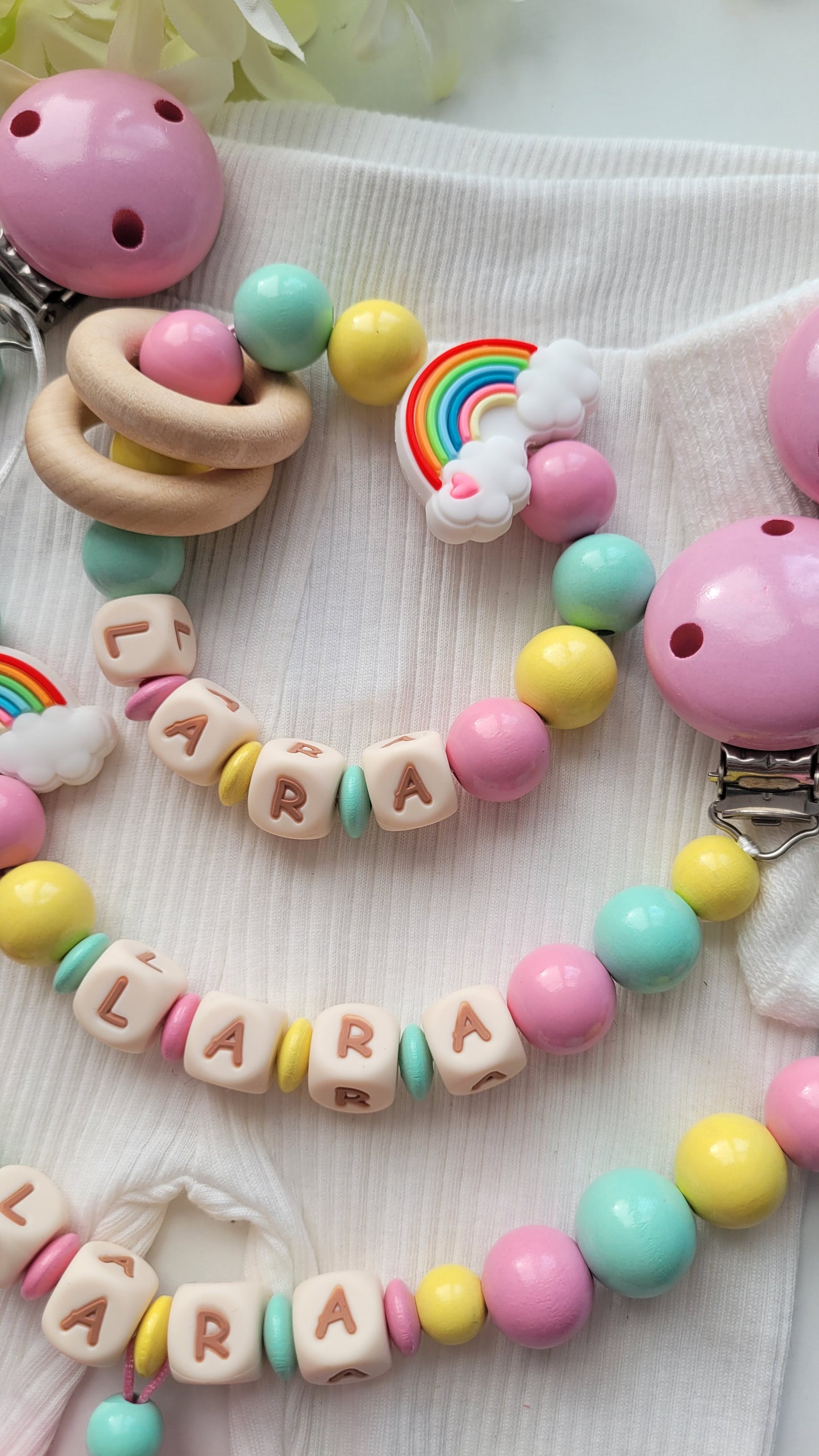 3er Set Schnullerkette, Kinderwagenkette & Greifring Regenbogen Pastellfarben
