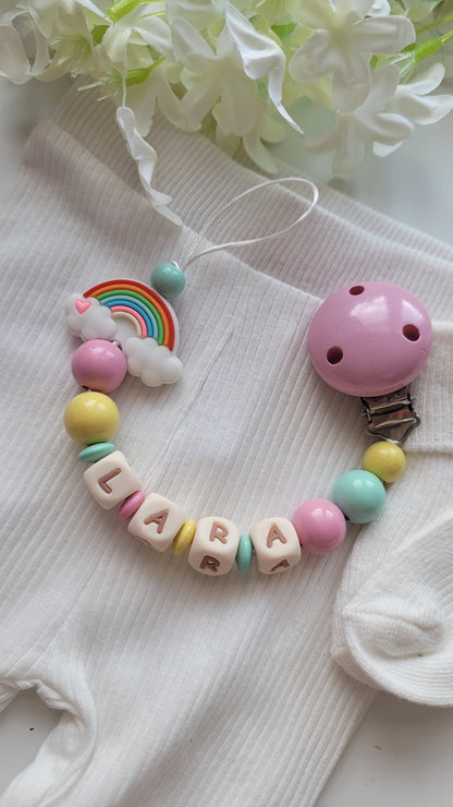 3er Set Schnullerkette, Kinderwagenkette & Greifring Regenbogen Pastellfarben