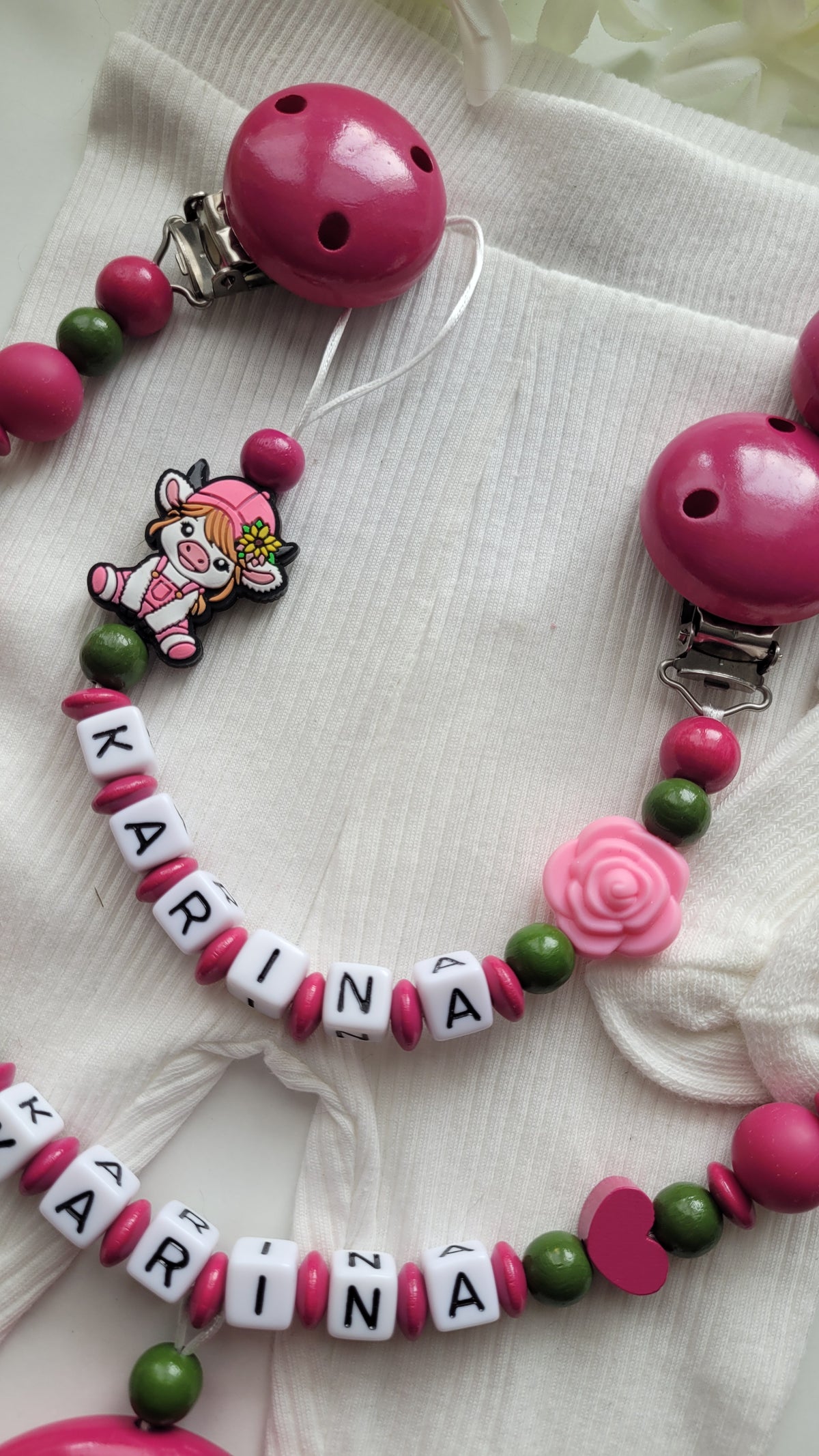 Kinderwagenkette & Schnullerkette mit Namen Kuh pink grün