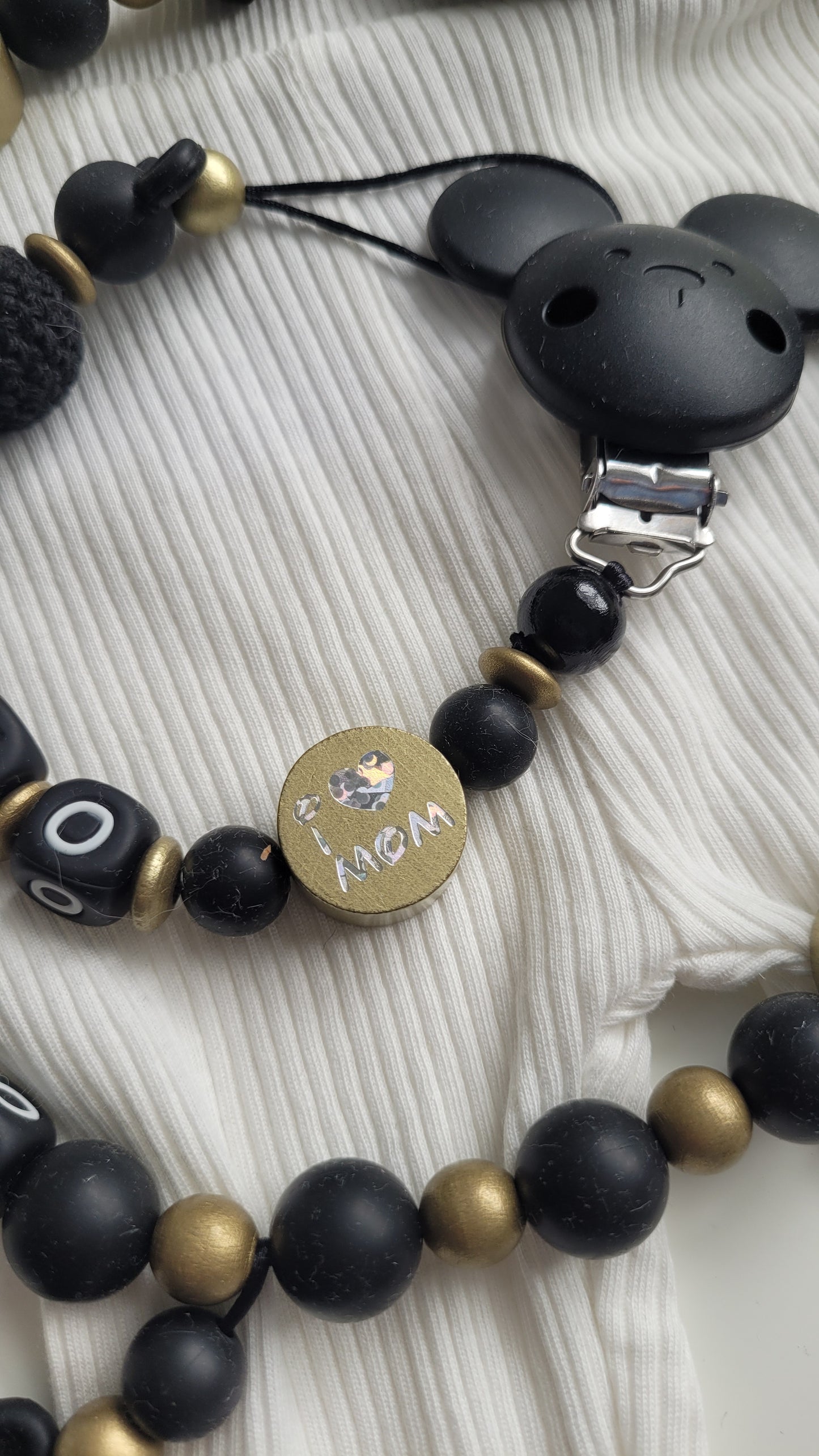 Kinderwagenkette & Schnullerkette mit Namen schwarz gold