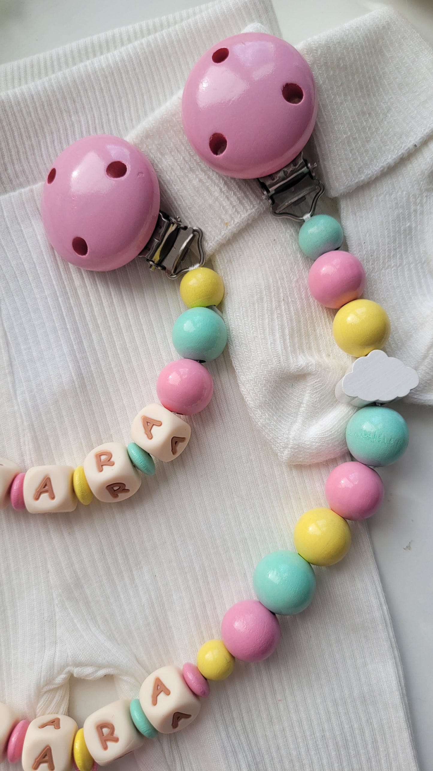 3er Set Schnullerkette, Kinderwagenkette & Greifring Regenbogen Pastellfarben